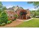 Beautiful brick home featuring manicured landscaping, green lawn, and a curved sidewalk at 1012 Chestnut Creek Dr, Villa Rica, GA 30180
