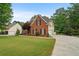 Beautiful brick home featuring manicured landscaping, large green lawn and long driveway at 1012 Chestnut Creek Dr, Villa Rica, GA 30180