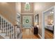 Grand foyer with hardwood floors, staircase, and a view of the front entrance and bedroom at 1012 Chestnut Creek Dr, Villa Rica, GA 30180