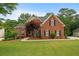 Charming brick two-story home featuring well-manicured lawn and a welcoming front entrance at 1012 Chestnut Creek Dr, Villa Rica, GA 30180