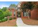 Close up of a charming brick two-story home with landscaped front yard and front door at 1012 Chestnut Creek Dr, Villa Rica, GA 30180