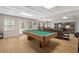 Finished basement game room with a pool table, plank flooring, and media area at 1012 Chestnut Creek Dr, Villa Rica, GA 30180