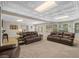 Finished basement with a game table, multiple couches, and bright lighting at 1012 Chestnut Creek Dr, Villa Rica, GA 30180