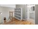 Hallway with hardwood floors showcasing a built-in shelving unit and a doorway to the bathroom at 1012 Chestnut Creek Dr, Villa Rica, GA 30180