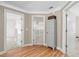 Upstairs hallway features hardwood floors and access to multiple rooms including one with built-in shelves at 1012 Chestnut Creek Dr, Villa Rica, GA 30180