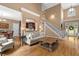 Spacious living room features hardwood floors, a fireplace, and staircase leading to the second floor at 1012 Chestnut Creek Dr, Villa Rica, GA 30180