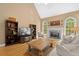 Cozy living room features a fireplace, hardwood floors, and built-in bookshelves for a comfortable atmosphere at 1012 Chestnut Creek Dr, Villa Rica, GA 30180