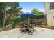 Outdoor dining area with an umbrella-covered table is situated on a paved patio with a retaining wall at 1012 Chestnut Creek Dr, Villa Rica, GA 30180