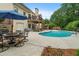 Inviting backyard pool area with outdoor dining, deck, and landscaped surroundings offers relaxation and entertainment at 1012 Chestnut Creek Dr, Villa Rica, GA 30180