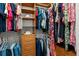 Spacious walk-in closet with custom organization, shelves, drawers, and hanging rods for clothing at 1012 Chestnut Creek Dr, Villa Rica, GA 30180