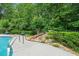 A beautiful rock waterfall feature adds a touch of nature to the landscaped pool area at 1012 Chestnut Creek Dr, Villa Rica, GA 30180