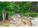 The serene rock waterfall and landscaping enhance the peaceful ambiance of the backyard at 1012 Chestnut Creek Dr, Villa Rica, GA 30180