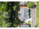 An aerial view showing a modern home with a well-maintained yard and gray shingle roof at 10565 Highgate Manor Ct, Duluth, GA 30097