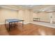 Recreation room with hardwood floors, large mirror, and ping pong table at 10565 Highgate Manor Ct, Duluth, GA 30097
