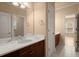 Bathroom featuring marble countertop, wood cabinets, and tile flooring at 10565 Highgate Manor Ct, Duluth, GA 30097