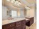 Primary bath featuring a double sink vanity with marble countertop and large mirror at 10565 Highgate Manor Ct, Duluth, GA 30097