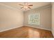 Bedroom with hardwood floors, crown molding, and a ceiling fan at 10565 Highgate Manor Ct, Duluth, GA 30097