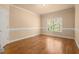 Bedroom with natural light and hardwood flooring, featuring crown molding at 10565 Highgate Manor Ct, Duluth, GA 30097