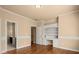 Bedroom featuring hardwood floors, built-in desk, and decorative moldings at 10565 Highgate Manor Ct, Duluth, GA 30097