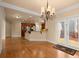 Dining area features hardwood floors, a chandelier, and convenient access to the kitchen and outdoor deck at 10565 Highgate Manor Ct, Duluth, GA 30097