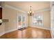 Dining area with wood floors, chandelier, and access to outdoor deck through glass doors at 10565 Highgate Manor Ct, Duluth, GA 30097