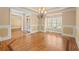 Dining room with hardwood floors, a chandelier, and wainscoting details at 10565 Highgate Manor Ct, Duluth, GA 30097