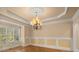 Dining room with wood floors, chandelier, and large windows for natural light at 10565 Highgate Manor Ct, Duluth, GA 30097