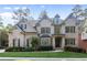 Charming two-story brick home with manicured lawn and lush landscaping at 10565 Highgate Manor Ct, Duluth, GA 30097