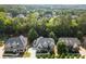 A beautiful exterior elevation showcasing a home in a neighborhood with mature trees at 10565 Highgate Manor Ct, Duluth, GA 30097