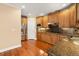 Kitchen with stainless steel appliances, wood cabinets, and granite countertops at 10565 Highgate Manor Ct, Duluth, GA 30097
