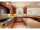 Kitchen boasts stainless appliances, granite counters, and open layout to dining area at 10565 Highgate Manor Ct, Duluth, GA 30097