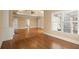 Open living space with hardwood floors, large windows, and neutral color scheme at 10565 Highgate Manor Ct, Duluth, GA 30097