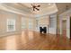 Spacious living room with a fireplace, hardwood floors, and built-in shelving at 10565 Highgate Manor Ct, Duluth, GA 30097