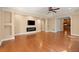 Spacious living room with hardwood floors, fireplace, and elegant ceiling fan at 10565 Highgate Manor Ct, Duluth, GA 30097