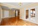 Living room with gleaming hardwood floors and view into the kitchen and patio at 10565 Highgate Manor Ct, Duluth, GA 30097
