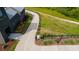 The walking path is adjacent to the building; there is a small trail off to the right with wildflowers at 10565 Highgate Manor Ct, Duluth, GA 30097
