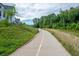 Walking path leading to residential area and surrounded by grassy hillside at 10565 Highgate Manor Ct, Duluth, GA 30097