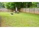Fenced backyard featuring mature trees and ample space for outdoor activities at 159 Misty Ridge Trl, Stockbridge, GA 30281
