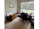 Bright bedroom with natural light from a large window and a dedicated desk area at 159 Misty Ridge Trl, Stockbridge, GA 30281