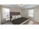 Modern bedroom with a large headboard, neutral tones, and bedside tables with lamps at 337 Torcello Blvd, Mcdonough, GA 30253