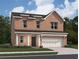Charming two-story brick home with a manicured lawn and attached two-car garage at 337 Torcello Blvd, Mcdonough, GA 30253