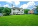 Large backyard with lush green lawn, patio with outdoor furniture, and view of the house at 6105 Overlook Park Dr, Cumming, GA 30040
