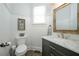 Half bathroom with white wainscoting, marble vanity, and hardwood floors at 6105 Overlook Park Dr, Cumming, GA 30040