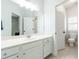 Bright bathroom with white vanity, large mirror and toilet in separate room at 6105 Overlook Park Dr, Cumming, GA 30040
