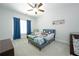 Charming bedroom featuring a toddler bed, blue accents, and natural light at 6105 Overlook Park Dr, Cumming, GA 30040