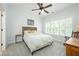 Comfortable bedroom with plantation shutters, a ceiling fan, and classic wood furniture at 6105 Overlook Park Dr, Cumming, GA 30040