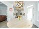 Open breakfast nook with a view into the kitchen and a modern light fixture at 6105 Overlook Park Dr, Cumming, GA 30040
