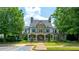 Beautiful clubhouse with stone and siding facade, surrounded by manicured landscaping at 6105 Overlook Park Dr, Cumming, GA 30040