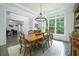 Formal dining room features a large table, natural lighting and refined traditional style at 6105 Overlook Park Dr, Cumming, GA 30040