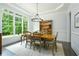 Sunlit dining room featuring a large window, wood table, and decorative chandelier at 6105 Overlook Park Dr, Cumming, GA 30040